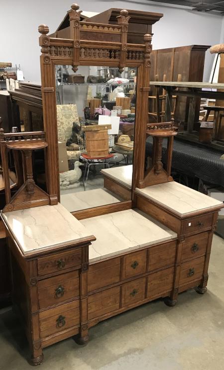 Antique Marble Topped Eastlake Mirrored Dresser: Antique Marble Topped Eastlake Style Mirrored Dresser With intricately carved design, inlaid floral detail, turned spindle accents, dovetail drawers, ball footed base and bronze toned metal drawer pul