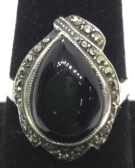 Onyx Sterling and Marcasite Ring: Sterling silver ring, fits approx size 8. Onyx stone tear drop cabochon, framed by marcasite. marked on interior band 925. 3.9 dwt with stones, minor surface wear Sterling silver, ladies vintage estat