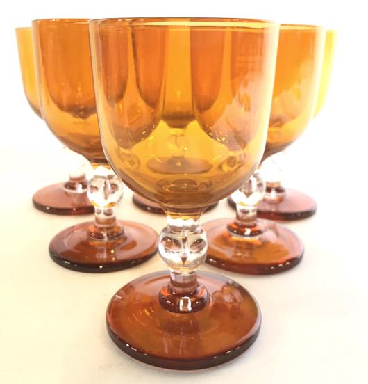 Set 6 Art Glass Stemware Vessels: Lot includes 6 art glass Stemware Vessels. Each are orange toned with clear spherical shape in center of stem. Each piece is thicker than other vessels of similar size. Wine glasses, beverage glasses,