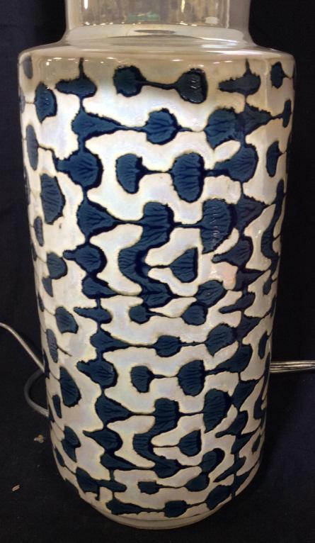 Iridescent Glazed Geometric Table Lamp: Modern Porcelain 3 way Lamp with fabric Drum Shade in white. Pearlescent luster, blue organic design, 5 ft cord. Glazed ceramic ‘lightbulb’ finial, and chrome shade and harp finishes. Appears new.