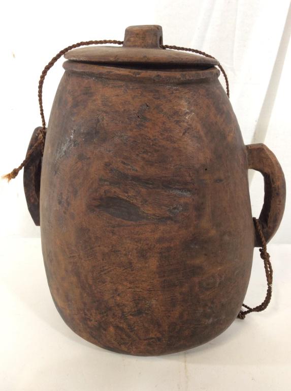 Primitive Nomadic Wood Jug with Top: Hand crafted wooden jug, lightweight, carry rope attached to handles and through lid knob. Meant to carry across body. Possibly Antique, 12 in ht, 11 in width. Primitive water Jug, Nomadic Carry all j