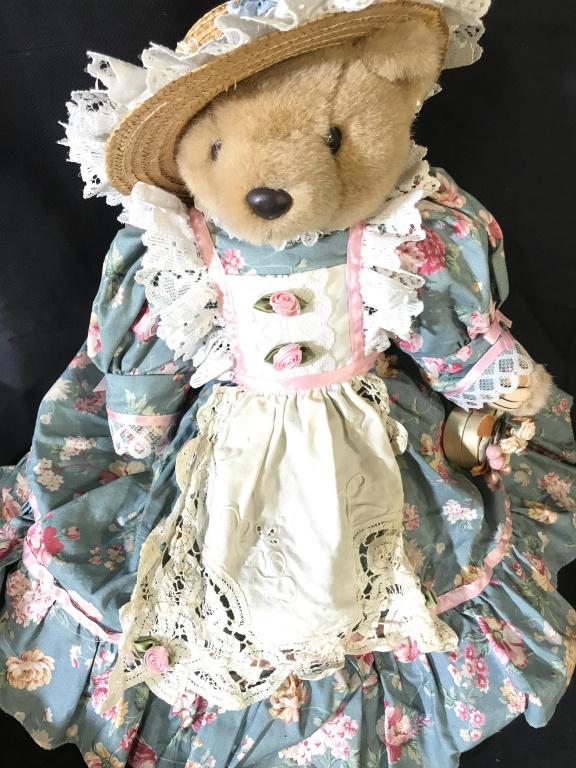 Bearly People Victorian Plush Collectible Bear: Bear is in blue floral dress with straw hat w/ ruffled fabric and flowers. Also wears an apron with ruffled sleeves, crochet corners and rosebuds. 19 in. Bear’s legs rotate to sitting position. She 