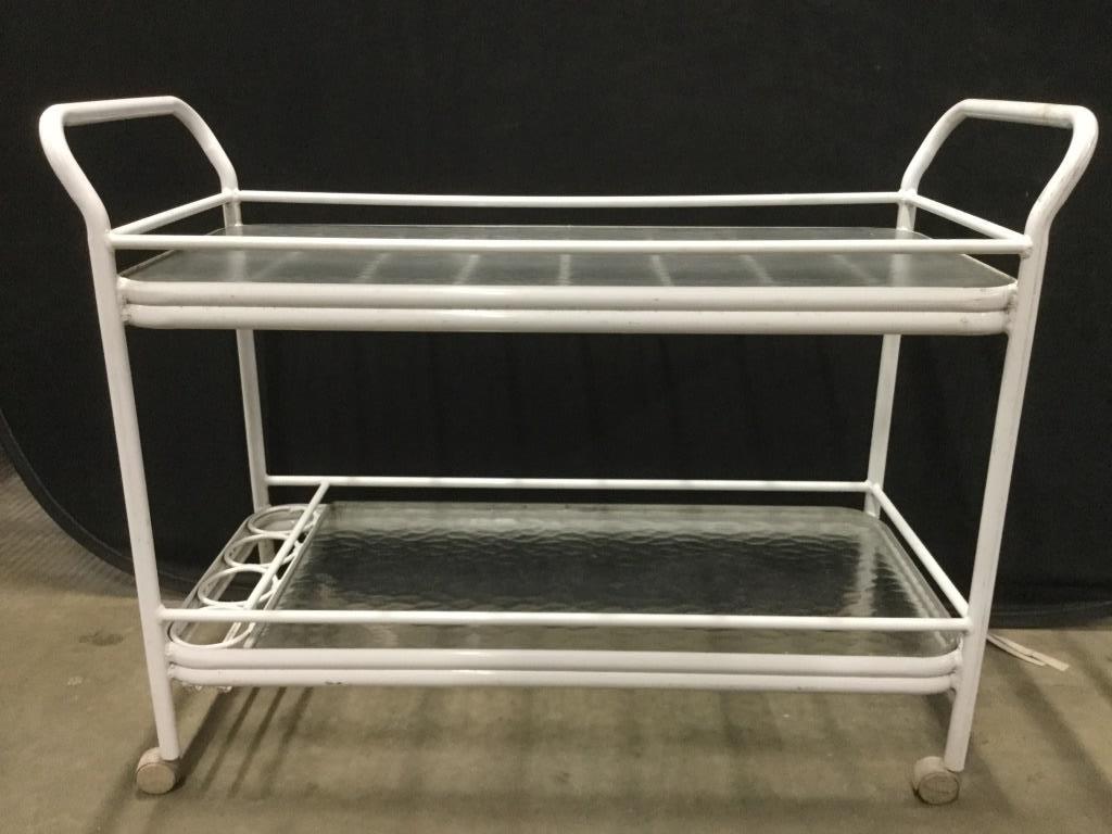 Vintage White Toned 2 Tier Outdoor Beverage Cart: Beverage cart frame is white toned. Piece has 2 tempered glass tiers. Contains 4 bottle holders on lower tier. Piece has handles on both side. Tea cart, bar cart, beverage cart, outdoor bar cart, meta