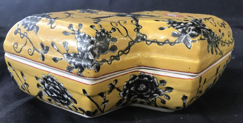 Signed Vintage Blossom Chinese Porcelain Box: Vintage porcelain box in shape of a double diamond, hand painted deep yellow with black & white blossoms and bird. Signed Asian characters in red on lid, impressed into porcelain. 8 in. long, 5 in. wi