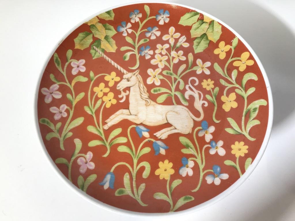 SEYMOUR MANN INC Porcelain Unicorn Tazza Dish: Cake dish is porcelain. Piece contains image of unicorn & floral & leaf detail. Piece is Pedestaled. Measures approx 10 inches wide 4.5 inches tall. tazza cake dish, tbaleware, centerpiece, decorative