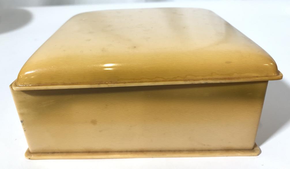 Vintage Bakelite Jewelry Box: Jewelry box appears to possibly be Bakelite. Exterior has gradient cream & beige tones. Jewelry box is vintage. Piece measures approximately 6 inches square 2.5 inches tall. Piece has some wear. May n
