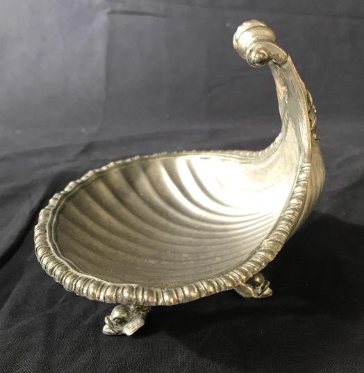 Vintage Detailed Metal Trinket Tray: This is a vintage Trinket tray, the piece is crafted to resemble a clam shell. The legs are crafted to resemble fish, and the face of a finned male figure can be found on the back of the tray. A small