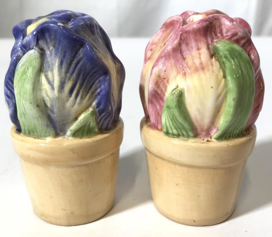 Porcelain Floral Salt & Pepper Shakers: Lot includes 1 salt and 1 pepper shaker. One shaker has a pink tone while the other has a lavender tone. Pieces measure approx 3.5 inches tall 1.5 inches wide. decorative accessories, tableware, table