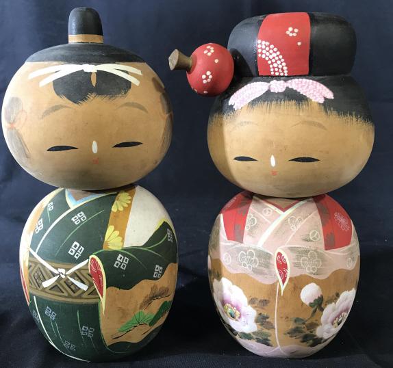 Pair Vintage Signed Hand Painted Asian Wood Dolls: This is a pair of vintage wooden dolls. The dolls are hand painted and for decorative use. The dolls are dressed in traditional Asian garb, the heads are articulated and can swivel as needed. The doll