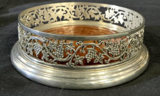 Silver Toned Metal & Wood Wine Bottle Coaster: Silver Toned Metal & Wood Wine Bottle Coaster With open work grape and vine design, blue velvet underside, marked on interior Patric Pewter, measures approximately 5.5 inches in diameter x 1.5/8 inche