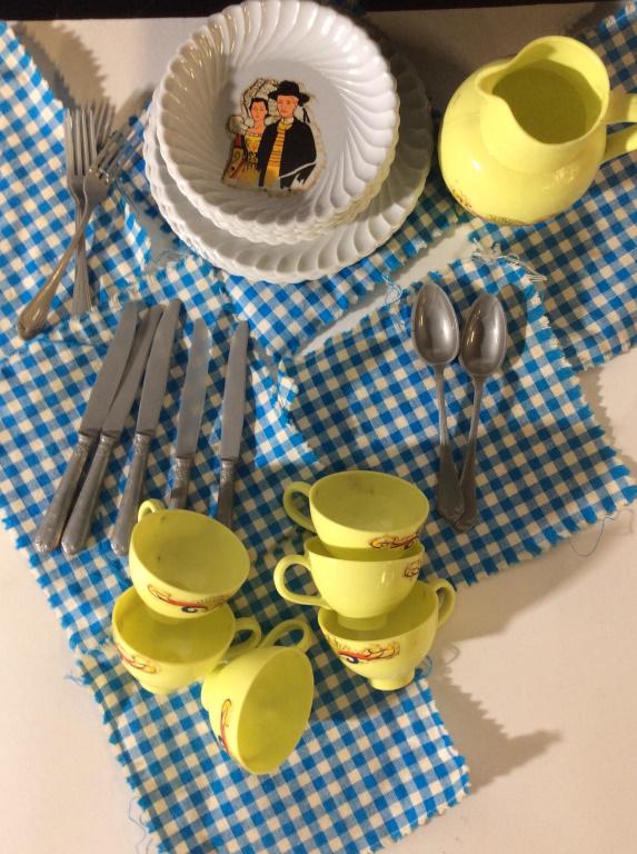 Mid Century HELLER Child’s Tea Set: Total pieces- 53. A picnic tea for 6. 6 tea cups, 6 Saucers, 6 luncheon/ dinner plates. 6 checkered napkins/table cloth, 3 forks, 5 knives, 2 spoons, 1 Pitcher. All plates marked Heller. Discoloration