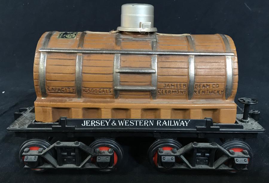 Vintage JIM BEAM Bourbon Railcar Bottle w Stand: Vintage Ceramic JIM BEAM bottle, fashioned to resemble a large wooden barrel, mounted on a railcar. The piece measures approx 7 inches H, 5.5 inches W, and 10.25 inches long. Minor wear is present on