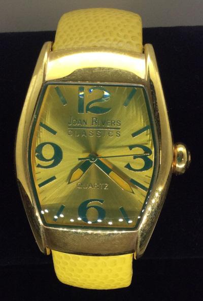 Signed Joan Rivers Quartz Wristwatch, Leather Band: Hinge Watch Band, Labeled genuine leather, embossed yellow. Large face watch, numbers 3,6,9,12. Hour min & seconds hand. Japan Movement. Stainless Steel back. 3/4 in wide strap, app 7 1/4 in. Weighted