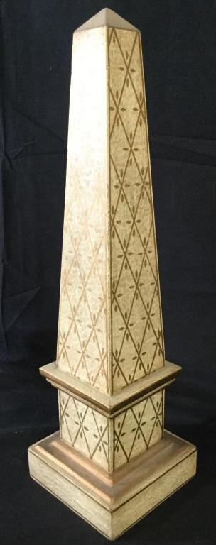 Cream & Gold Toned Obelisk Figure: Obelisk is cream toned with gold toned detail. Piece appears to possibly be wooden. Piece measures approximately 18 inches tall 5inches square. Obelisk, obelisk Figure. Contains some wear. tabletop ac