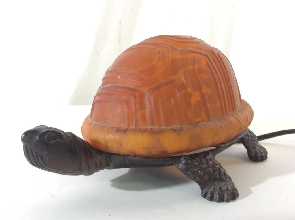 Signed Turtle Figural Metal W Art Glass Lamp: Underside of lamp is signed illegibly. Piece has metal base and orange toned art glass shell shade. Turtle lamp, animal lamp, art glass lamp. Piece measures approx 9 inches long 4 inches tall 5.5 inch