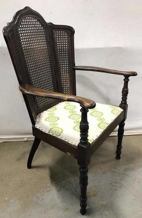 Antique Carved Wooden Armchair With Caned Back: Antique Carved Wooden Armchair With Caned Back, turned front legs and Upholstered Seat with nailhead trim, some slight wear to wooden finish in areas, measures approximately 40 inches tall x 25 inches