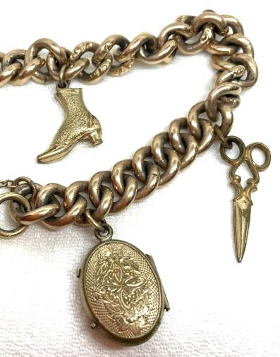 Gold Filled Charm Bracelet: Gold filled, clasp reads 1/20 12 k GF. Charms include victorian boot, scissors, key and locket, discoloration and some missing pieces, interior of locket cracked. Measures approx 7 1/2 in long. Vintag
