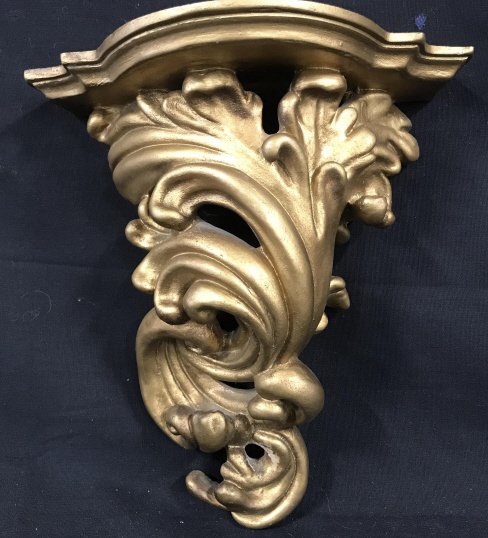 Pair Sirocco Style Demilune Bracket Wall Shelves: Ornate accent shelf, shelf top length 8.25 in, widest width4 in, narrower width 1.25 in. Total length, 10 in. Possibly plaster & wood materials. Bracket hole width app 9 mm. No hardware included. Wall