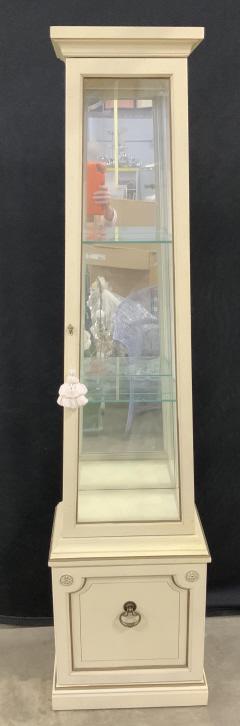 Vintage Obelisk Shaped Curio Cabinet: Vintage Obelisk Shaped Curio Cabinet with speckled cream toned background, bronze toned painted trim and brass toned handle on lower door, unit has internal light and two glass shelves, light not test