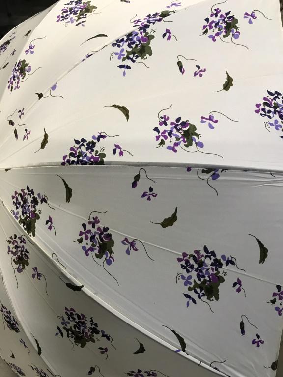 Lot 7 Vintage Promenade Parasols: Purple flowers in white, leather J handle cover, no issues. Bejeweled J handle, silk fabric, has rips, mechanics are fine. Reads ‘hand made in Italy. Scalloped edge vintage linen with straight wood 