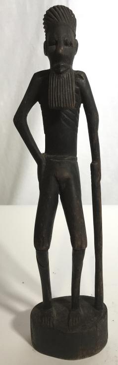 Carved Wooden Elderly Make Figure: Piece is wooden with intricately carved detail. Piece is possibly African possibly middle Eastern. Piece depicts an elderly male figure with walking stick . Piece measures approx 12 inches tall 3 inch