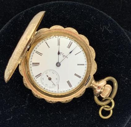 Elgin Pocket Watch, Gold Filled: Scalloped edge, watch face reads Elgin, American, possibly produced c 1887, century, intricate etched details of floral filigree and landscape, working at time of lotting, needs servicing. interior of
