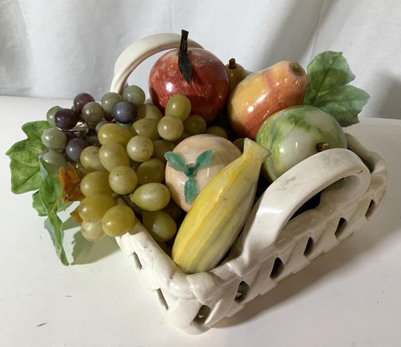 Stone Fruit & Ceramic Basket: A white two handled ceramic basket filled with six stone fruit to include a banana, pear, apple, peach, and lime that are nestled into a grape and vine plastic base, measures approx 8.5 inches in diam