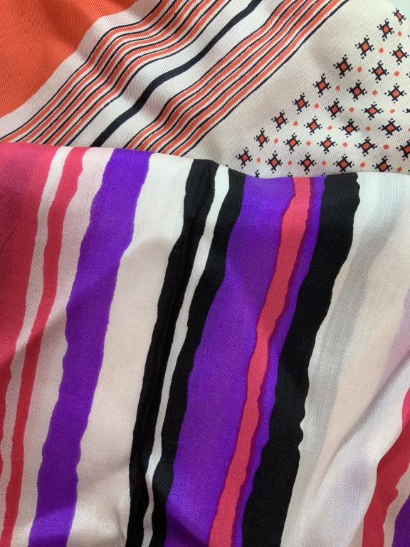 Pair Silk Fashion Scarves: One with bright pink nd purple stripes mixed with black and white, measures approx 44 in by 14 in. One orange geometric line and square design, 27 in square, both have evident discoloration and tears,
