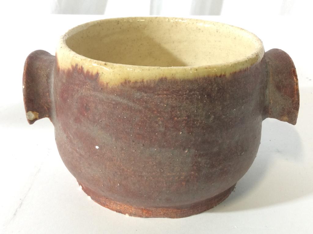 Vintage Handled Handmade Ceramic Bowl: Bowl is handmade. Piece contains 2 arch shaped handles. Outer area has a rusted red toned while interior has banana cream tone. Handmade ceramics, handmade ceramic bowl, handled ceramic bowl. tablewar