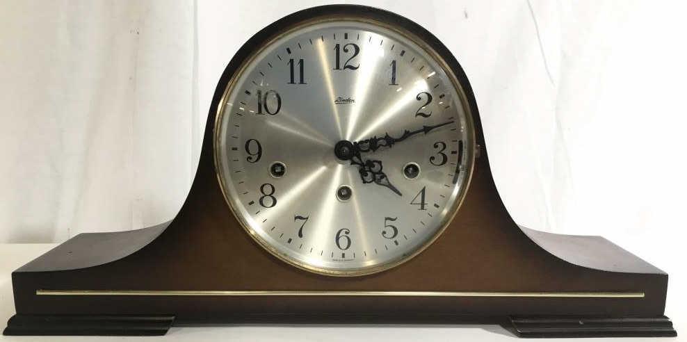 Vintage LINDEN Wooden German Mantel Clock: Clock face is marked LINDEN MADE IN W. GERMANY. PIECE appears to be wooden. Contains bell curve shape. Clock face is silver toned with black toned hands and numbers. Piece measures approximately 19 in