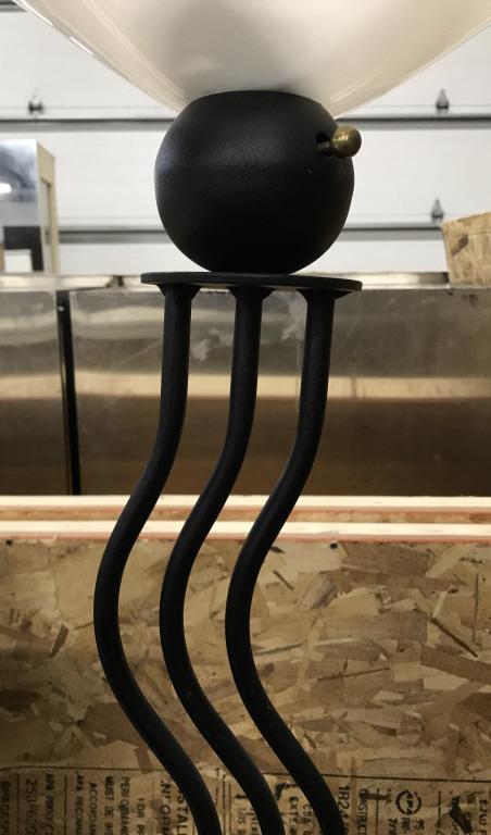 Metal Repeating S Curve Floor Lamp: Floor lamp is black toned. Piece has wavy repeating s curve structure. Base is circular. Piece has white toned shade. Piece measures approx 69 inches tall 16 inches wide. home lighting, contemporary d