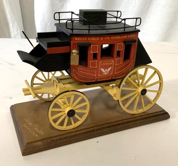 Vintage Style Wells Fargo Model Mail Carriage: Wooden model Wells Fargo mail carriage. in vintage style. Body of carriage reads Wells Fargo & co. Overland Stage US Mail. Base reads Oscar Morten 2014 USA. Bottom reads oscars old west miniatures 70t