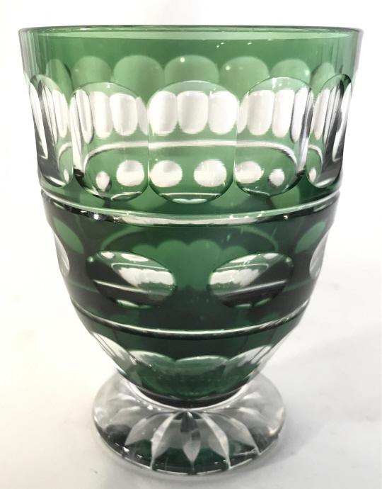Green Toned Art Glass Footed Bohemian Glass Vessel: Vessel is green toned with clear geometric pattern detail. Piece is footed . Piece measures approximately 4.75 inches tall 3.5 inches wide. Bohemian glass, art glass, art glass vessel, tabletop access