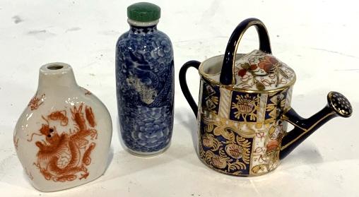 Lot of 3 Asian porcelain collectibles: Lot includes 2 Asian style snuff bottles and 1 Asian style watering can. Blue snuff bottle measures approx 3 inches tall. No markings found. Inside of cap is worn due to use and add. Dragon and floral