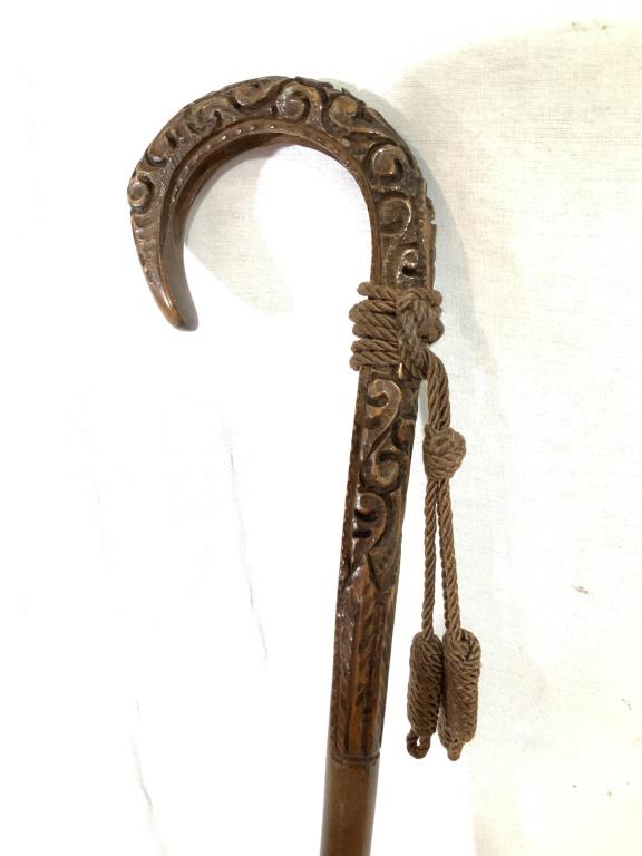 Vintage Hand-carved Umbrella, Italy: This piece is a vintage umbrella. The wooden handle is hand carved and decorated with several tassels hanging from it. The tip of the umbrella is also crafted from wood. The tag on the interior read m