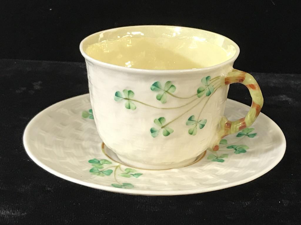 Shamrock BELLEEK Irish China Demitasse + Saucer: 2 pcs. Tea for one. Very fine bone China, embossed basket weave and painted shamrocks on demitasse cup and saucer. Trademark stamp in green on undersides of both, Reg. # 0857 on saucer and cup with Ce