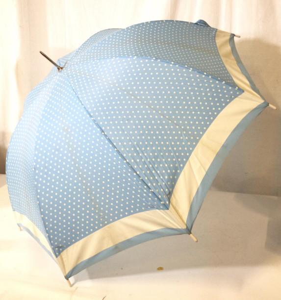 CHARLIE BY REVLON Polka Dot Umbrella: Umbrella appears to be vintage. Piece is light blue toned with white toned polka dots. piece measures approximately 34 inches tall, 38 inches wide when fully open. Umbrella, vintage umbrella, polka do
