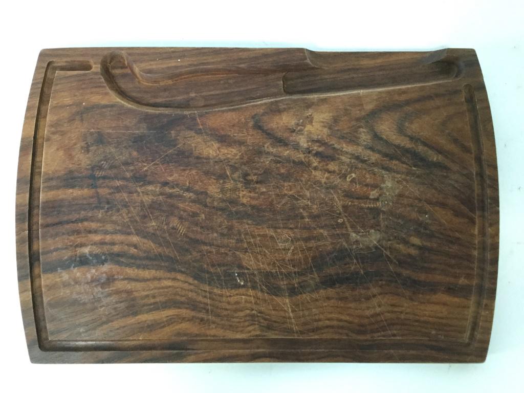 Vintage Carved Wooden Cheeseboard: Cheeseboard is brown toned and wooden. Piece has area carved out for cheese knife. Cheese board, wooden cheese board, tableware vintage cheese, carved wooden cheese board. Piece measures approx 14 inc