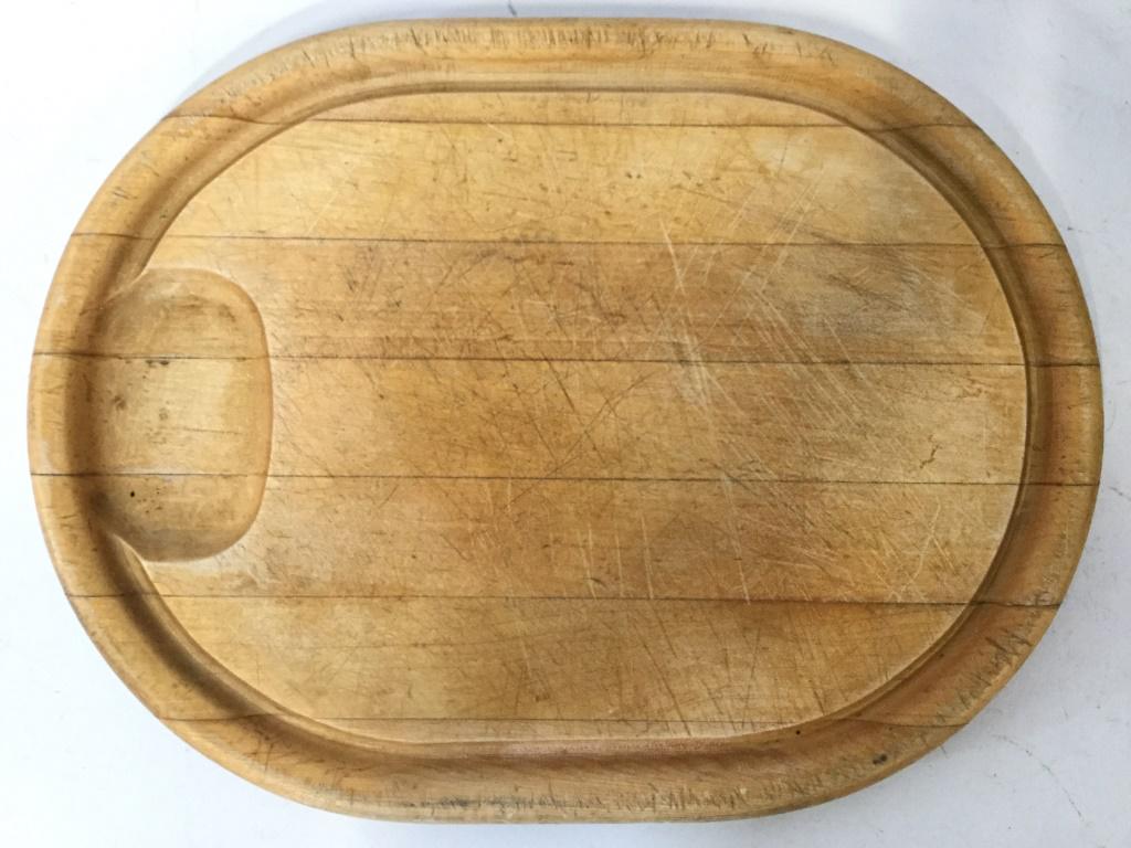 MASTER CARVER BY ADAMS Carving Board: Underside is marked MASTER CARVER BY ADAMS. Piece is tan toned and oval shaped. Cheese board, carving board, carved wooden cheeseboard, wooden carving board. tableware Piece measures approximately 16 