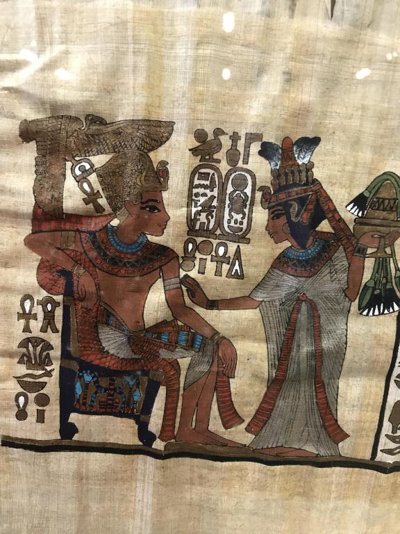 Framed Egyptian Paint on Papyrus, Vintage Piece: Papyrus, or rice paper, is an ancient material derived from plants. Art depicts King Tut with eagle over his head, holding him in the key of life, Queen is affectionately touching his shoulders. She a