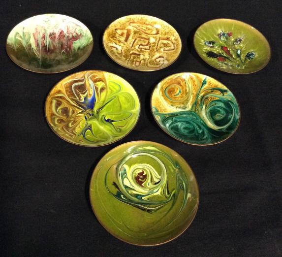 Set 6 Vintage Copper & Enamel Plates, Chile: This is a set of six copper plates, the face of the plates is colored with enamel in varying patterns and tones. The plates are signed on their underside, illegibly. Chile is also etched into the unde