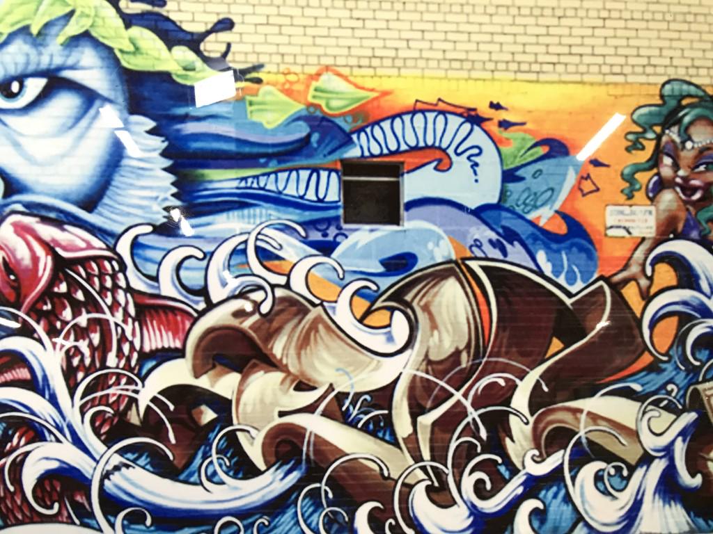 Signed Grafitti Print on Aluminum: This piece is a grafitti print, the print is on Metal. The piece is signed and numbered along its lower right section. The piece is signed illegibly, the number reads 1/200. The print depicts an ocean