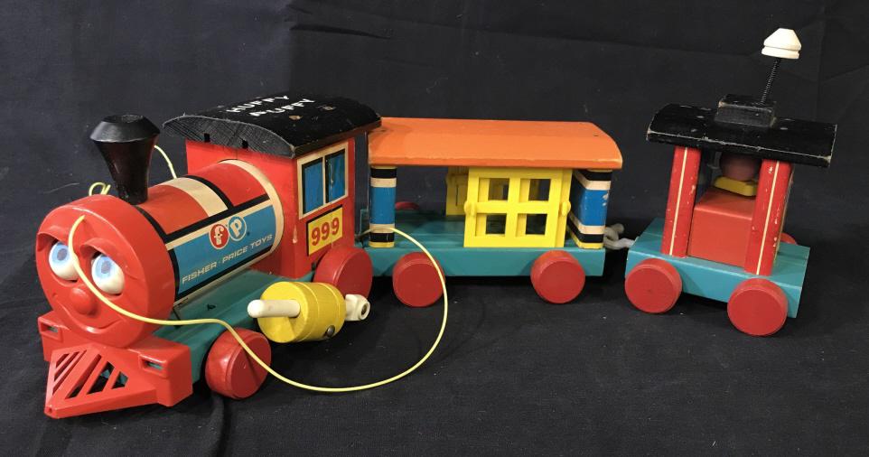 Vintage Fisher Price HUFFY PUFFY Toy Train: This is a vintage toy train set Freon fisher price. The piece is an anthropomorphized train, HUFFY PUFFY, is written along its roof. The piece measures approx 19 inches long, and 4.5 inches H. A pull