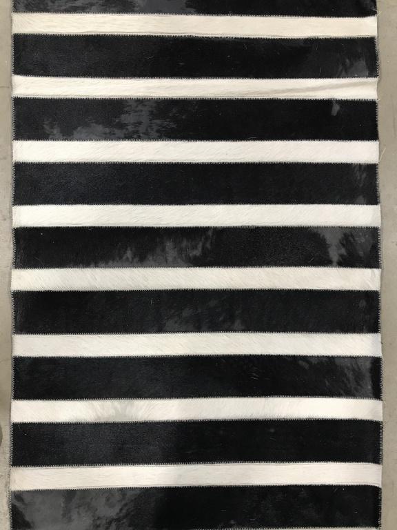 Striped Zebra Hide Hallway Runner: Runner appears to possibly be Zebra Hyde. Piece has black and white toned stripes. Piece measures approximately 280 inches long, 26 inches wide. Runner, rug, hallway rug, striped rug. Contains some we