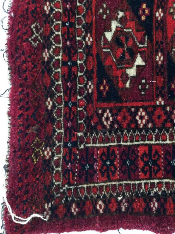 Middle Eastern Vintage Wool Prayer Carpet: App 18 x 17 in. Side section ripped. Underside hand sewn/ mended and reinforced so edges do not fray. Reticulated geometric patterns in square and border design. Overall color, cranberry & red. Elemen