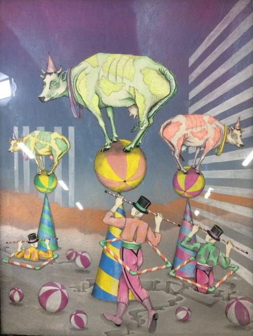 Israeli Artist Orna ben Shoshan, Mixed Media: Signed By Artist, lower left, ‘Orna’ Depicts circus theme with performers balancing gigantic cows on colorful beach balls which are balancing on cones. Framed Mixed media on paper- Layered paper a