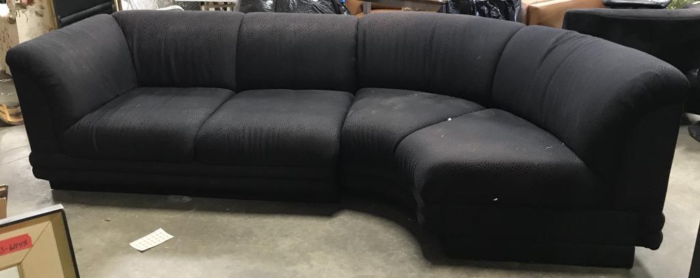 Vintage Black Toned Upholstered Sectional: Sectional is black toned. Piece appears to be vintage. Sectional, black sectional, vintage sectional, couch, sofa. Piece measures approx 108 inches long, 50 inches deep, 30 inches tall. Piece has some