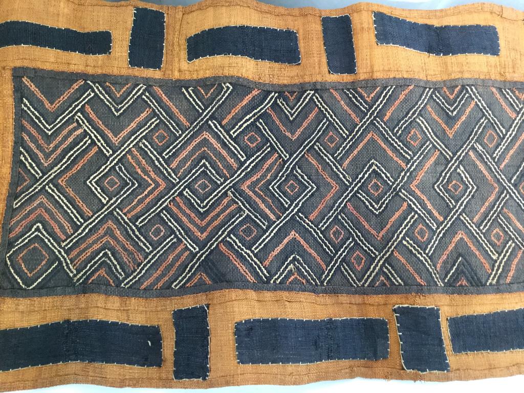 Kuba African Woven Raffia Tapestry, Congo: Handmade raffia Tapestry/ furniture cover/ table runner/ wall hanging. Patchwork sewn designs, using dyed colors black, brown, orange, & natural. 18 in wide, 72 in. Long. Kuba Raffia Textiles, Hand Se