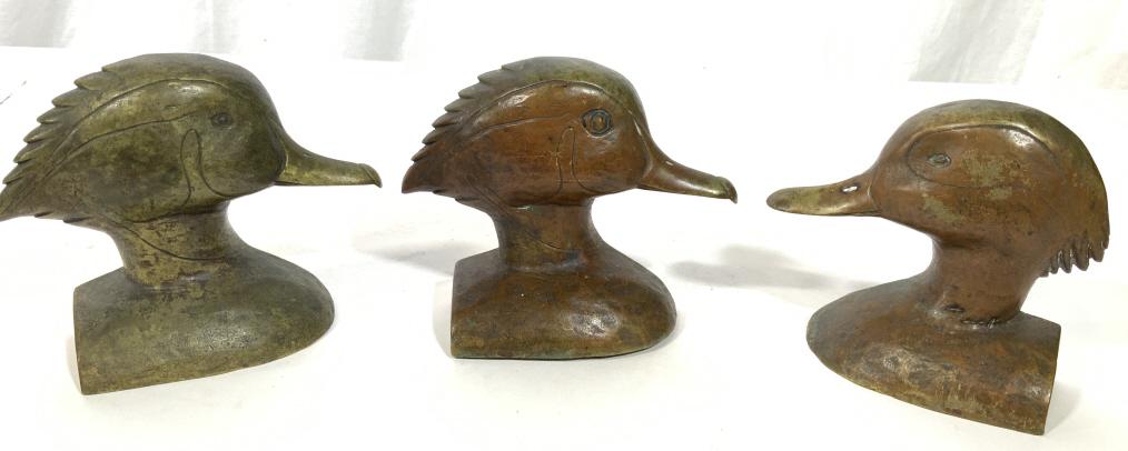 Lot 3 Vintage Bronze Iron Duck Door Stops: This is a set of three vintage, metal iron and/or bronze door stops. The pieces have been sculpted to resemble wood ducks. The pieces measure approx 4 inches H and 5.25 inches W. There is some wear pr