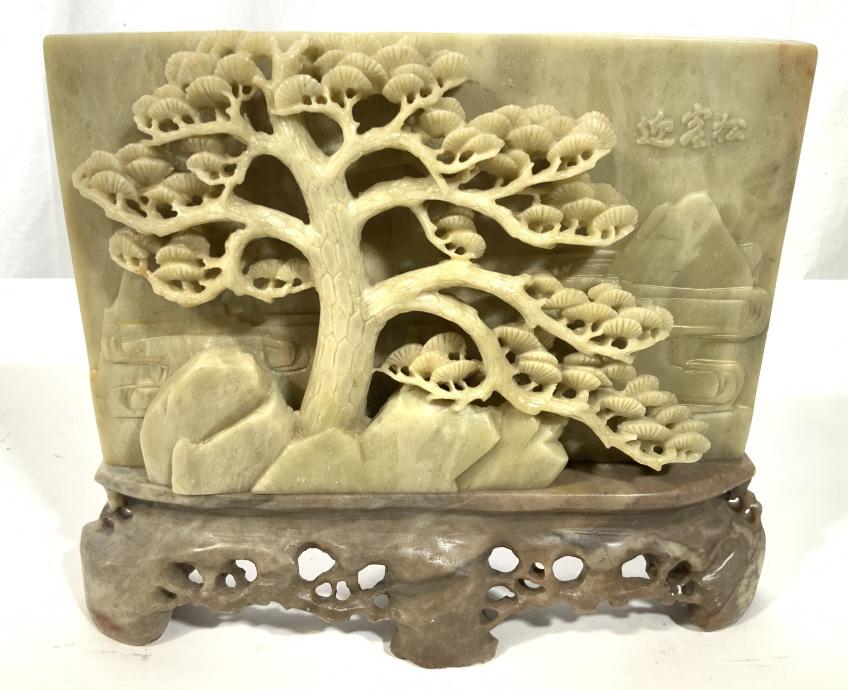 East Asian Style Carved Stone Sculpture: This is a hand carved marble sculpture. The piece depicts a tree growing among a rocky outcrop, mountains and clouds can be found in the backgrounds. Asian characters are present in the upper right co